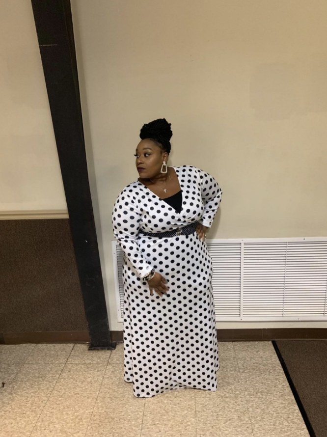 a reviewer wearing the long-sleeve maxi dress in black and white 