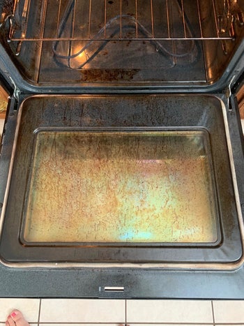 Reviewer photo of dirty oven before using Goo Gone cleaner