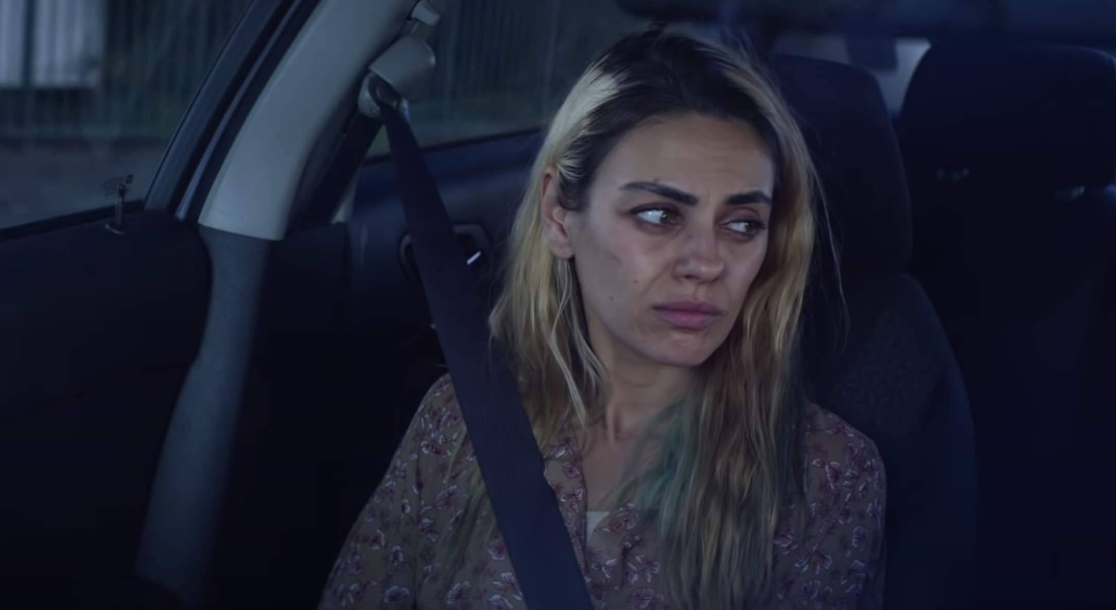 Mila sits in the passenger seat of her mother&#x27;s car in the film 