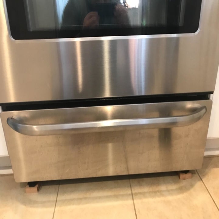 Reviewer photo of oven door before using stainless steel cleaner