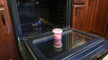 Reviewer photo of The Pink Stuff in front of dirty oven