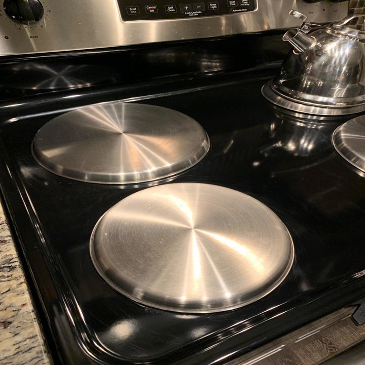 Reviewer photo of electric stove top with burner covers