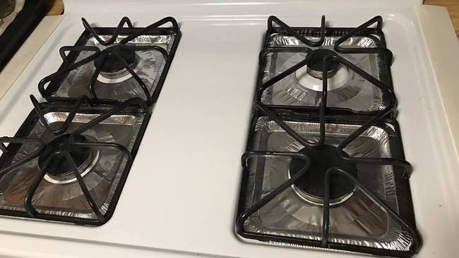 Reviewer photo of foil liners placed on gas stove range