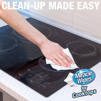Model using Miracle Wipe on stove top