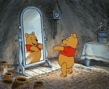 GIF of Winnie the Pooh dancing in front of a mirror