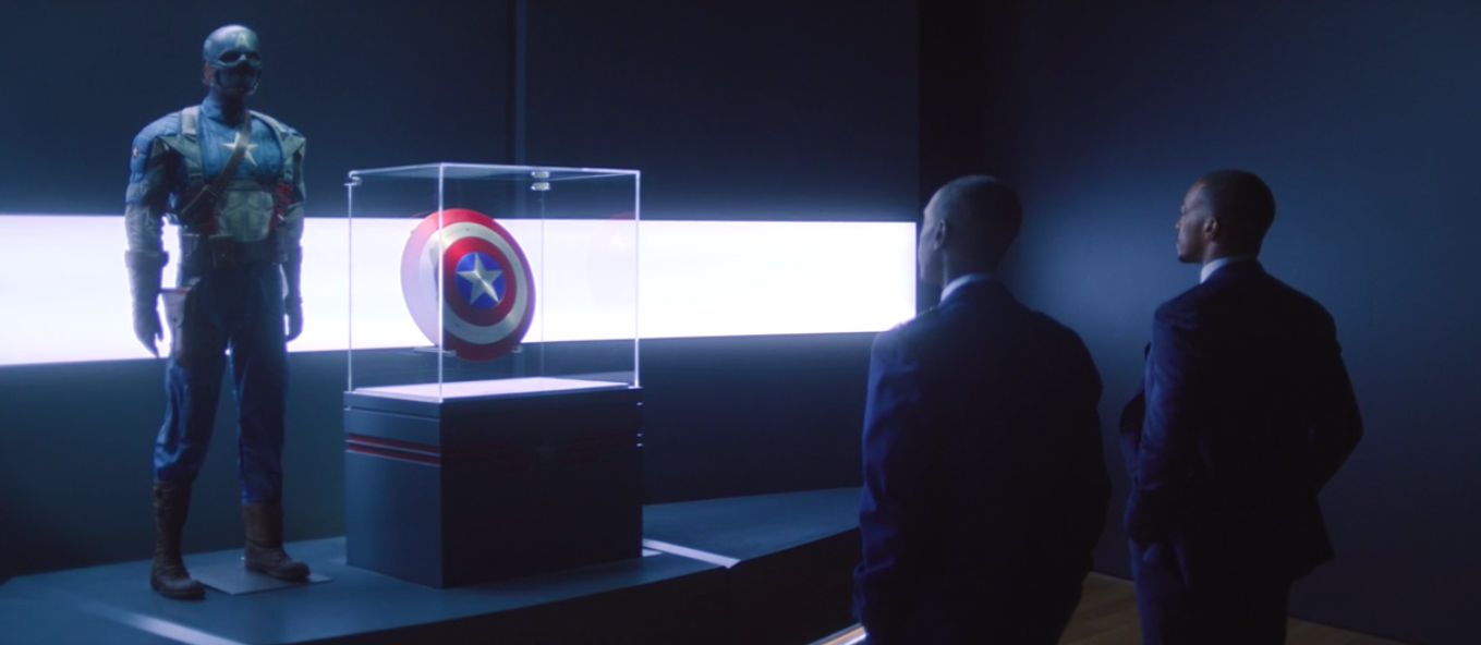 Don Cheadle and Anthony Mackie standing in a Captain America exhibit