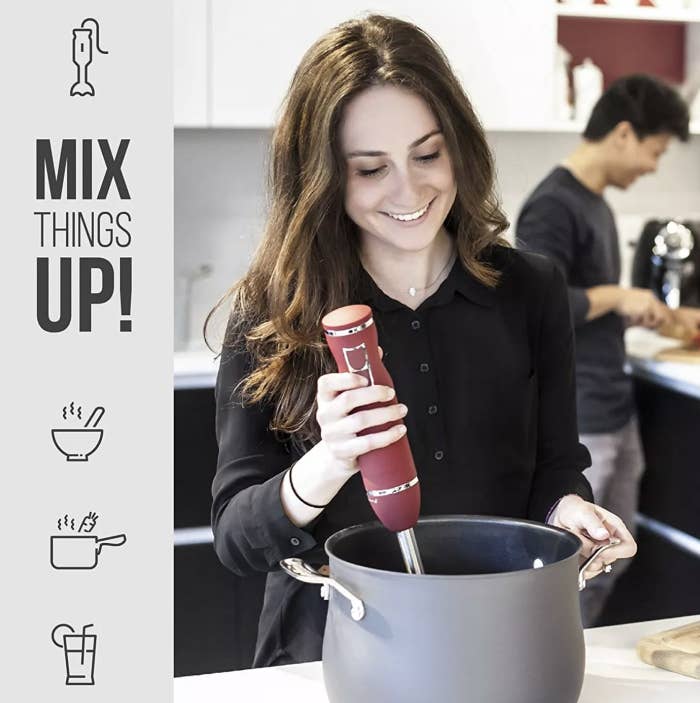 A person using an immersion blender