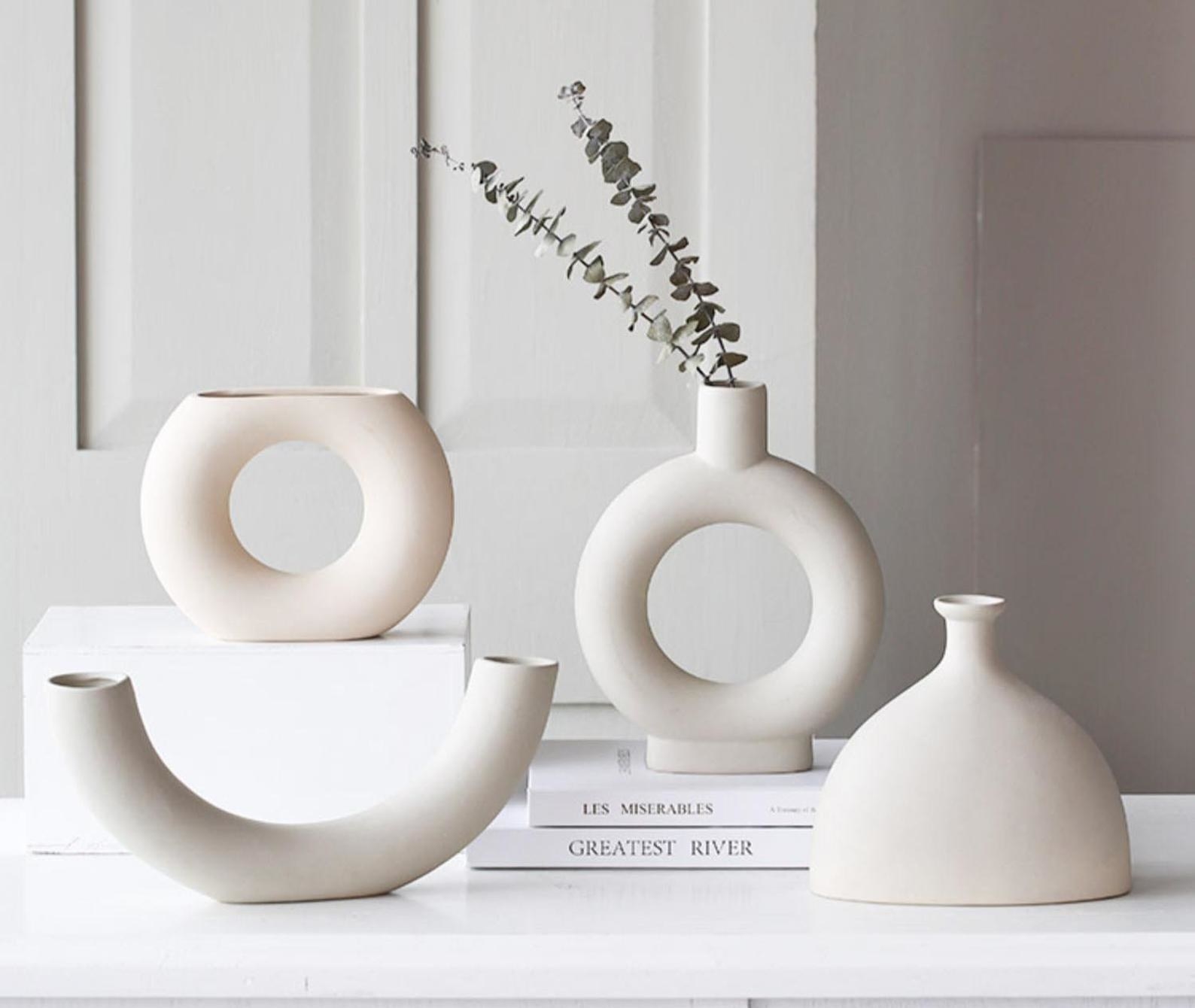 four beige geometric vases