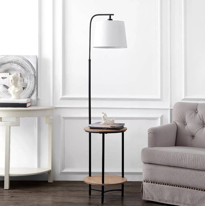 The wood and black metal floor lamp with two shelves