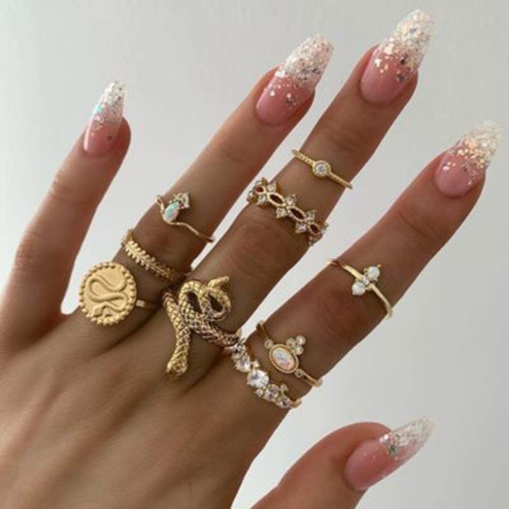 A hand wearing all the rings in the set