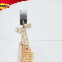 A shower brush hanging on the hook