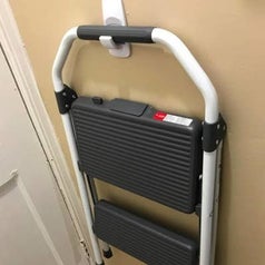 A customer review photo of their step ladder hanging from the hook