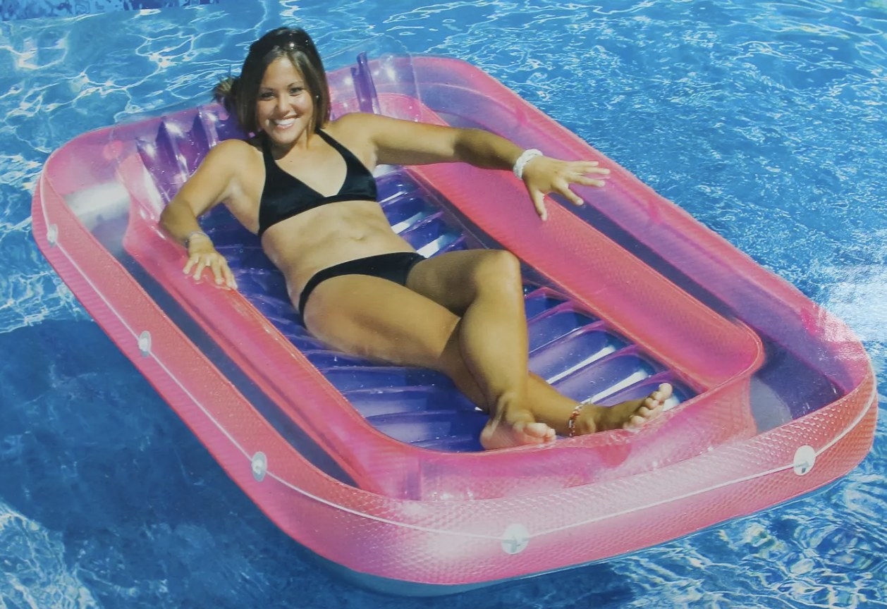 A person lounging on a pool float in a pool