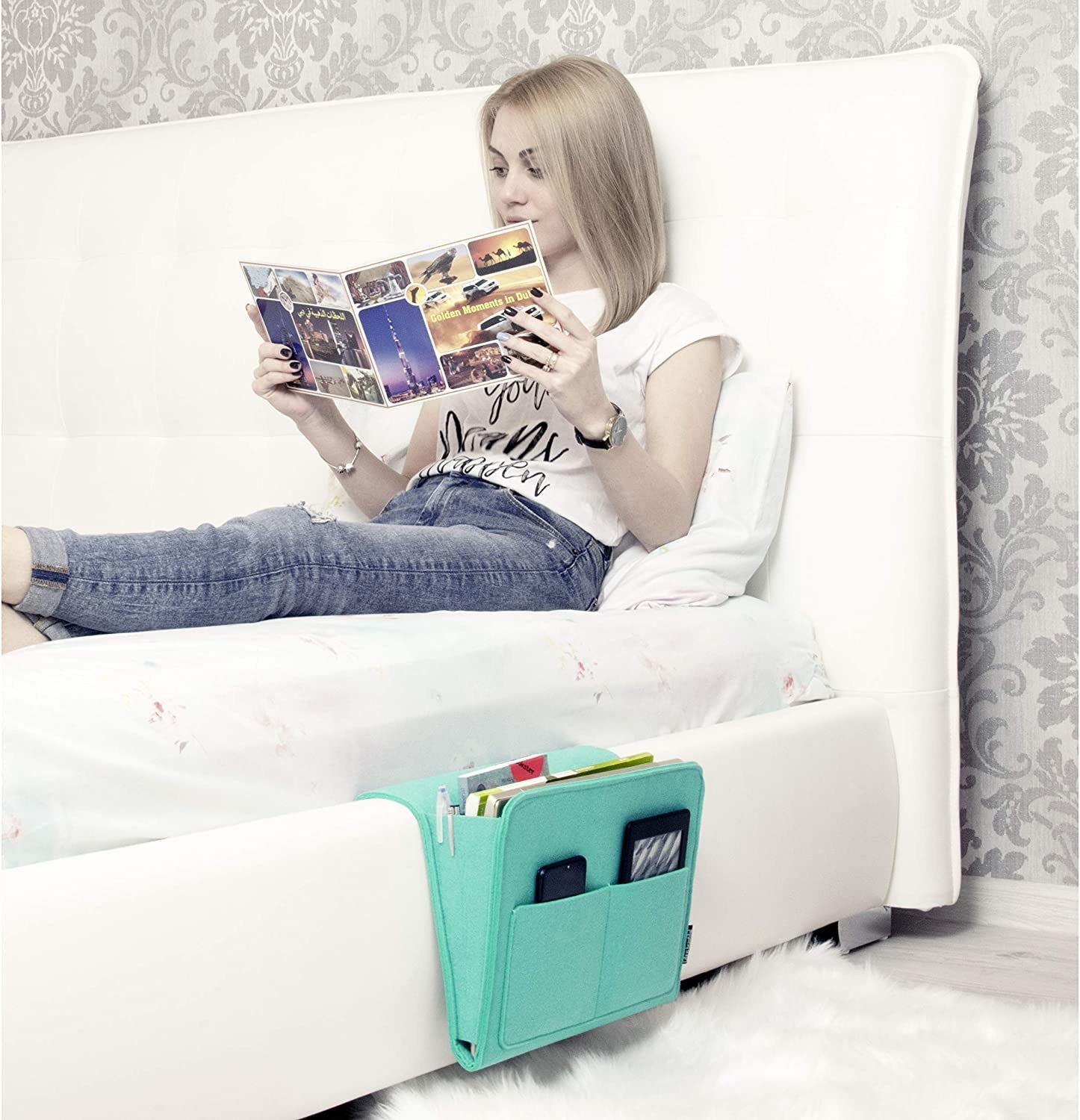 model lounges on bed with green bedside caddy on the side
