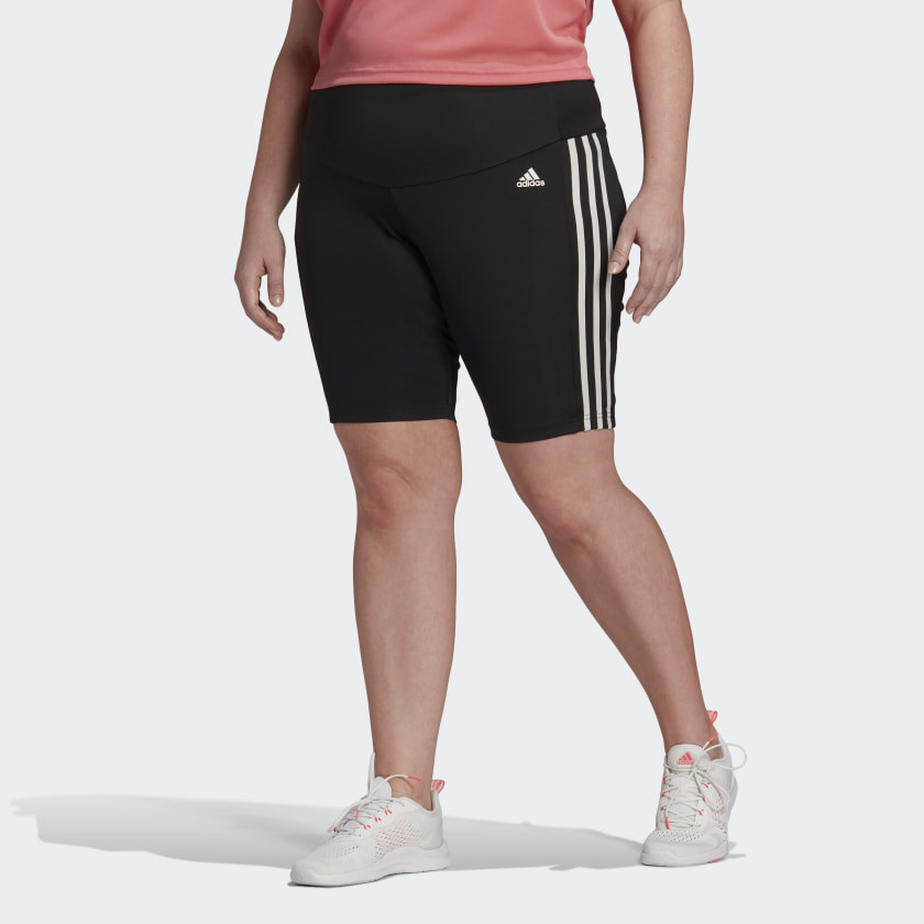 Model wearing black shorts with three white lines on the side