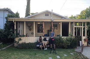 Exterior of a house with production happening outside.