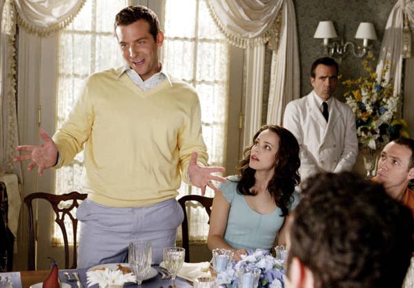 Sack stands next to Claire at a table in Wedding Crashers 