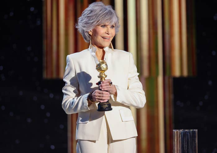 Jane holds her award while speaking