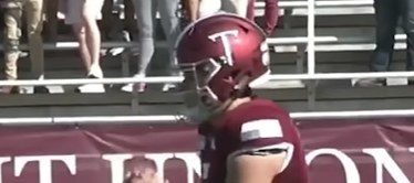 Maroon helmet with a white &quot;T&quot; that looks like a sword