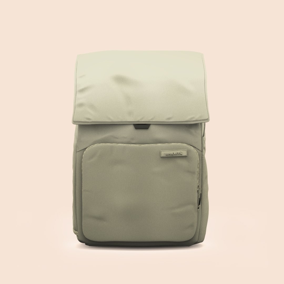 Green backpack on peach background