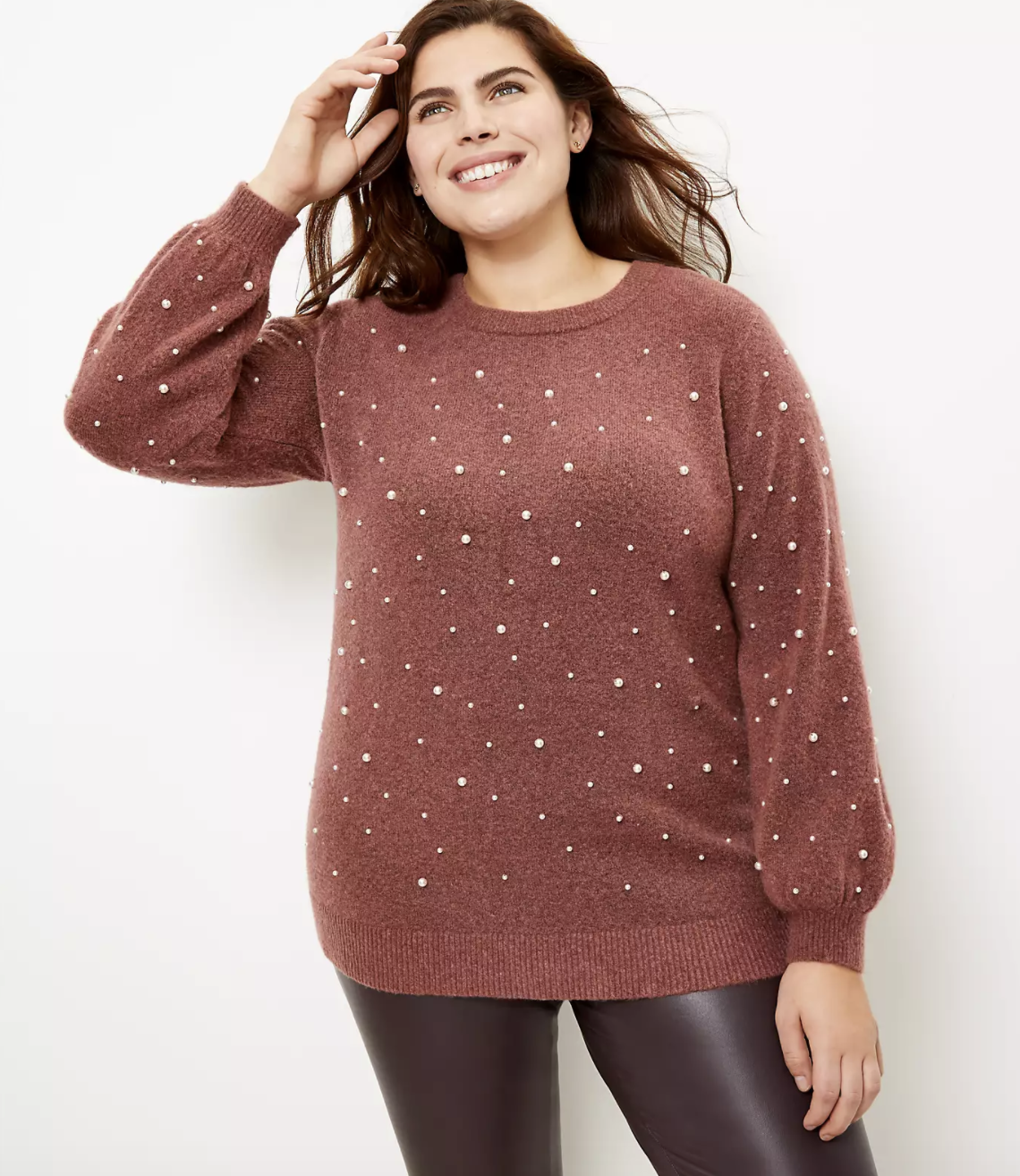 model wearing pearl embellished sweater with leggings