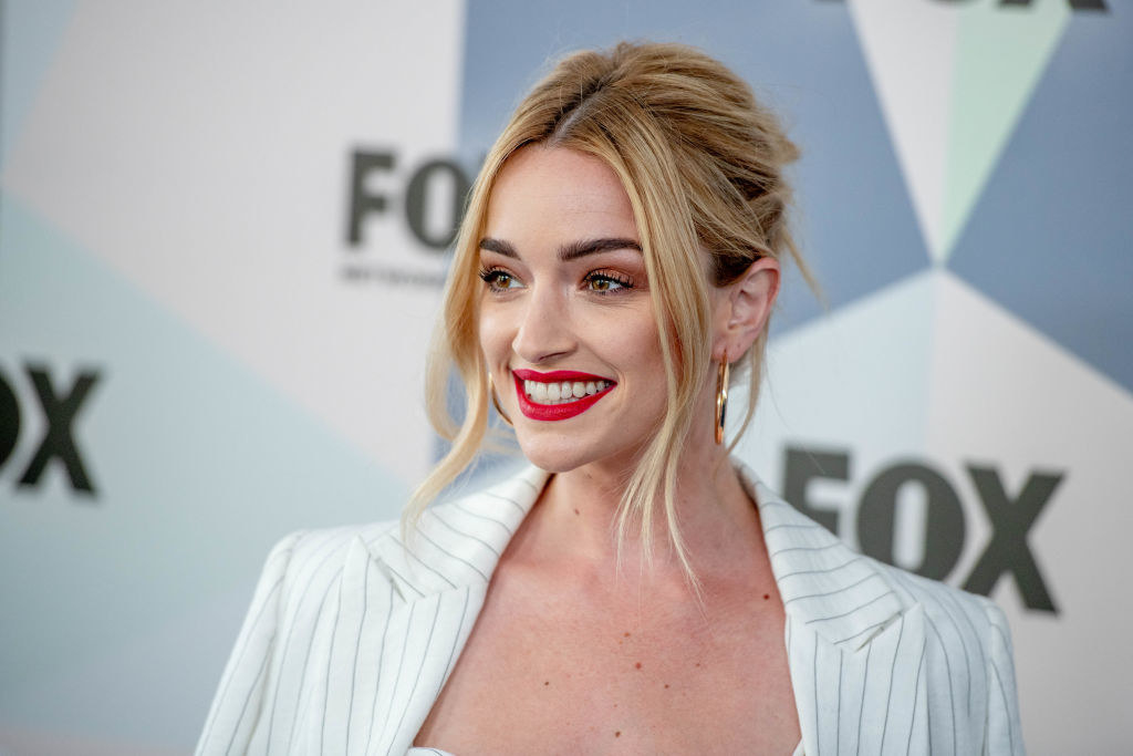 Brianne wearing a striped blazer and messy updo on the red carpet