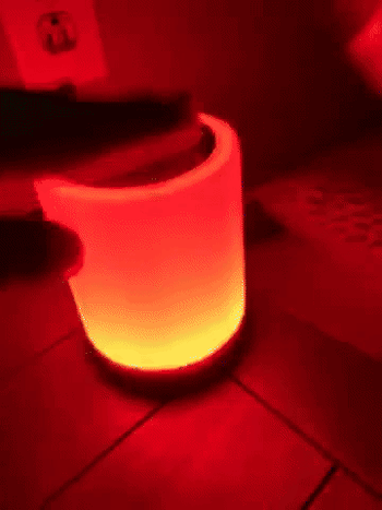 Reviewer tapping the light to change its colors 