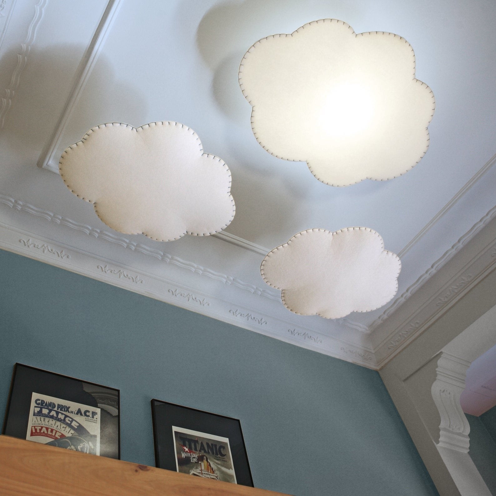 three cloud lamps hanging from a ceiling