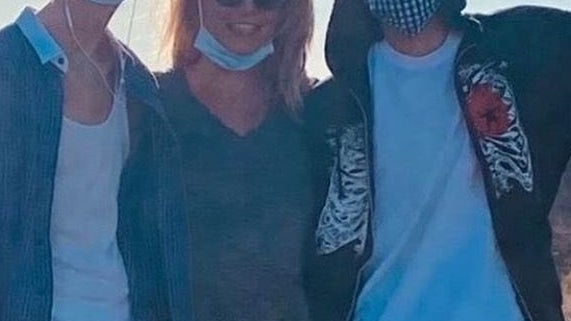 Britney smiles with her face mask down as she poses with her sons