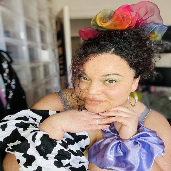 buzzfeed editor with a large scrunchie in her hair and two on her wrists