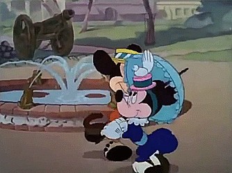 GIF of Mickey walking by Minnie in the park, with both dressed in 1890s clothing