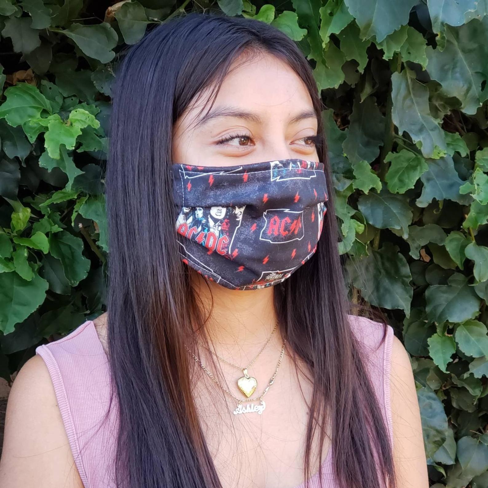 Model in black AC/DC mask