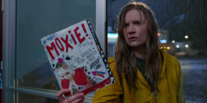 Vivian holding up a copy of the zine