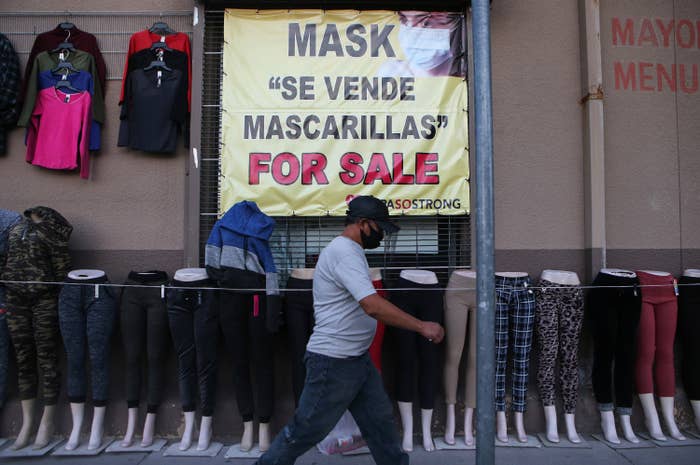 A storefront shows a sign that reads "masks for sale"