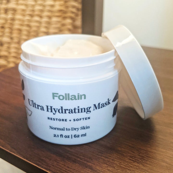 A small jar of Follain Ultra Hydrating Mask with the screw-on lid removed to see the whipped, creamy texture