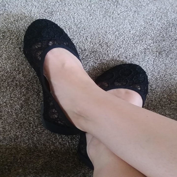 reviewer wearing the flats in black