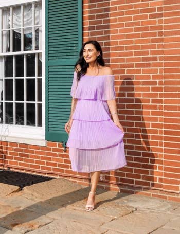 Reviewer wearing the dress in lilac with neutral heels 