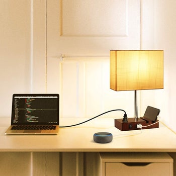 USB and outlet lamp placed on desk with laptop