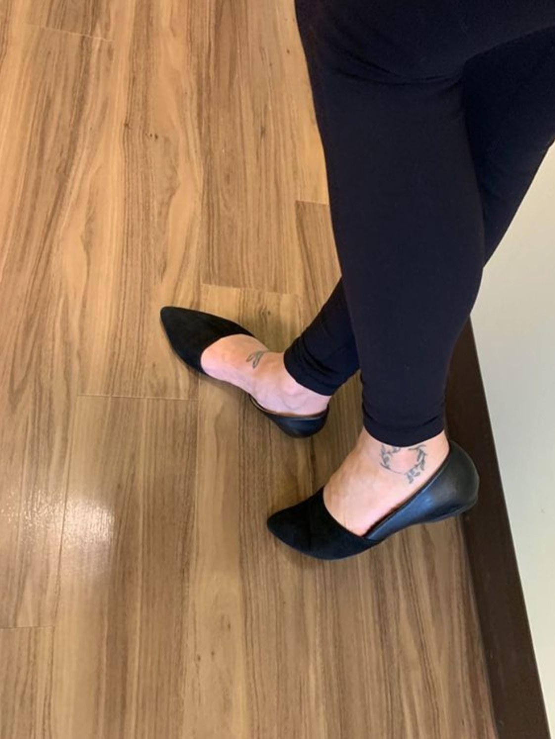 A reviewer wearing the flats in black