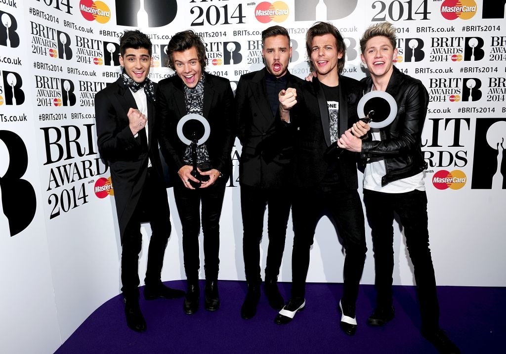 One Direction holding their Brit Awards in 2014