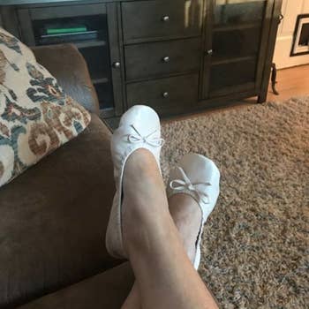 A reviewer wearing the flats in neutral