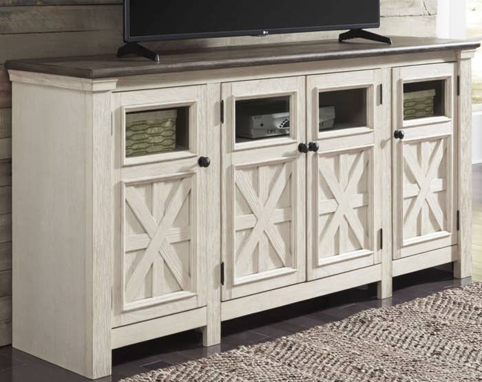 A TV stand in a light white wood