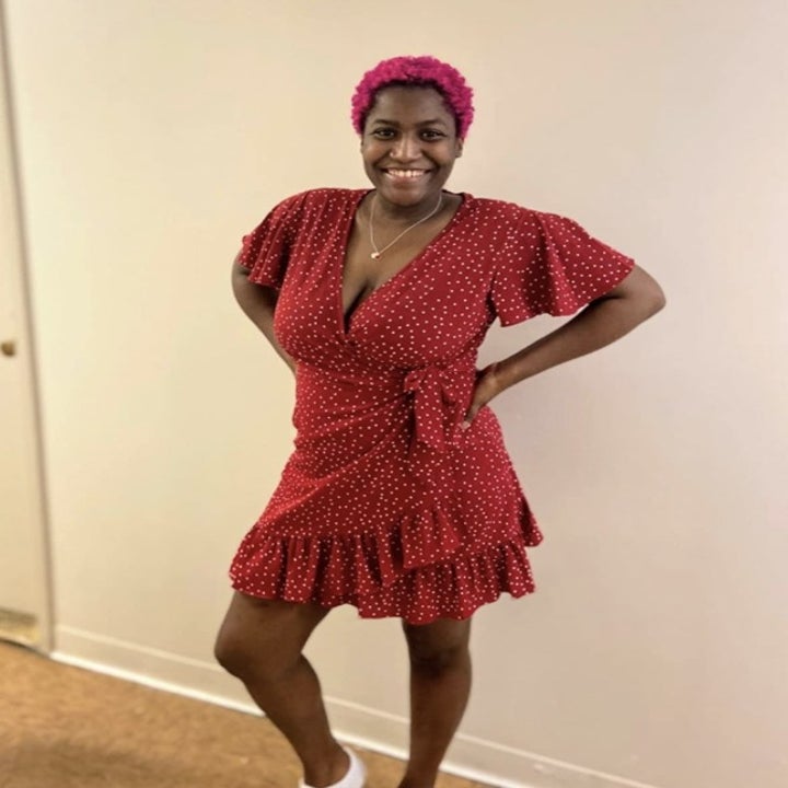 a reviewer wearing the dress in red 
