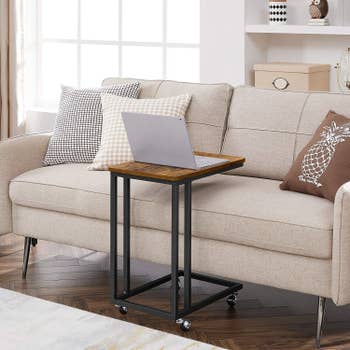 Rolling side table placed next to couch