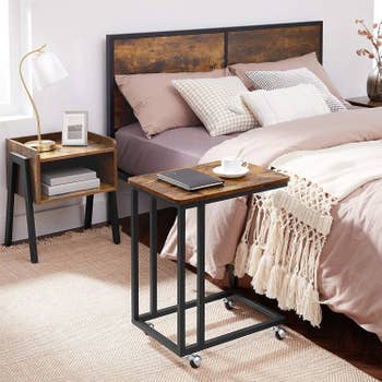 Rolling side table placed next to bed