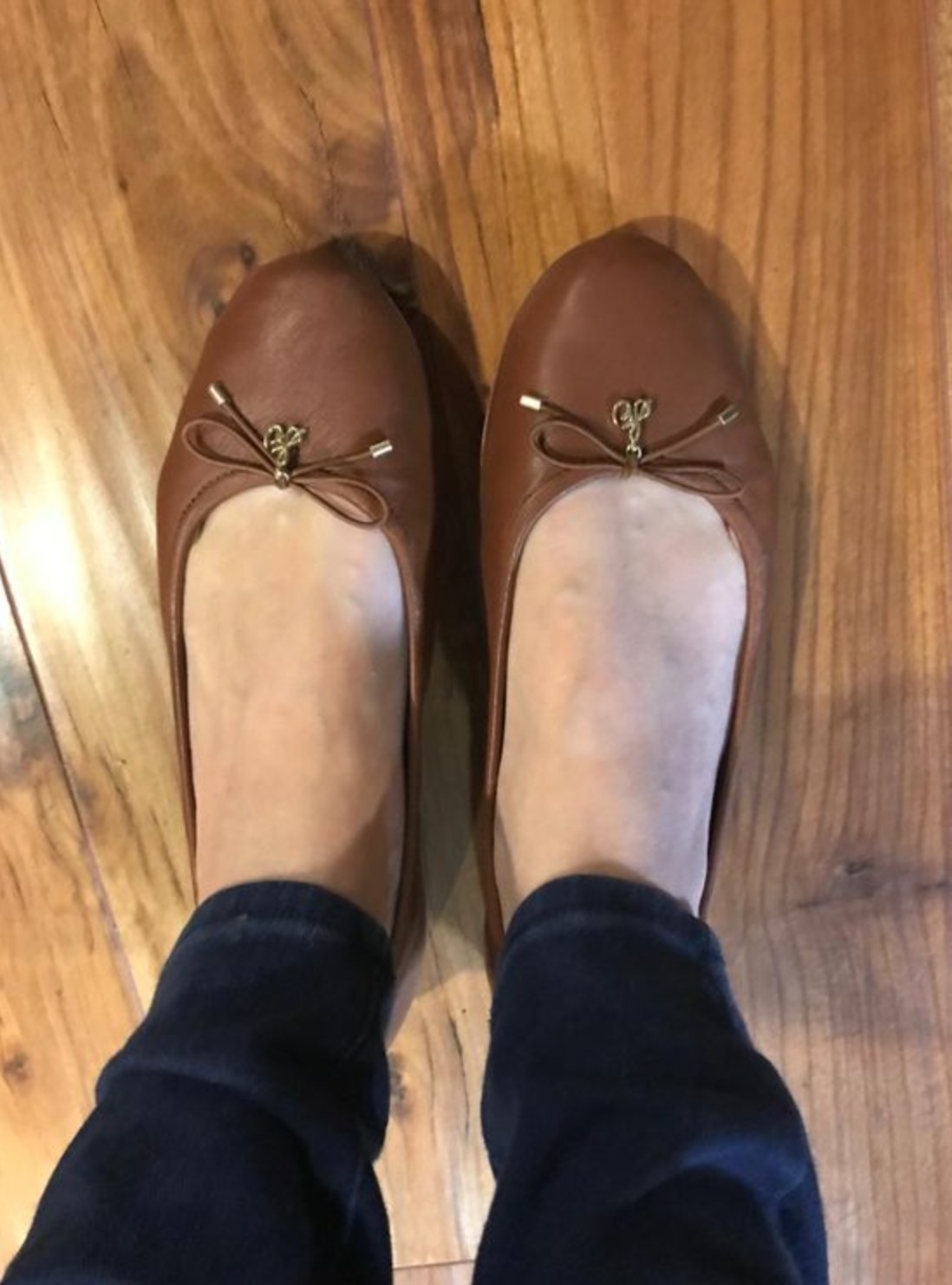 A reviewer wearing the flats in saddle leather