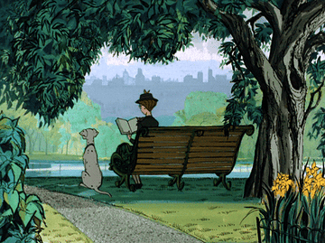a gif of anita and perdita from 101 dalmatians sitting on a bench reading in a park