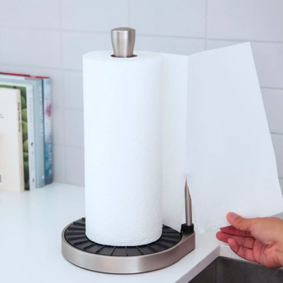 Someone tearing away a single sheet of paper towel