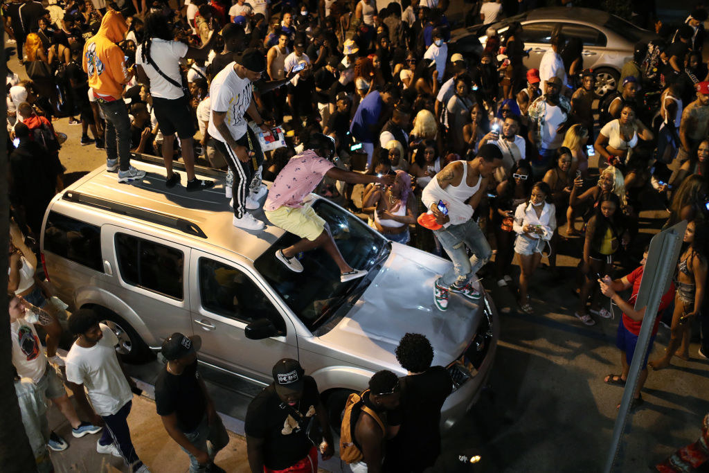 people standing on a car