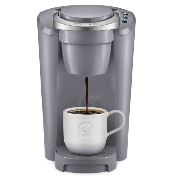 the gray Keurig coffee maker  making. a hot cup of coffee